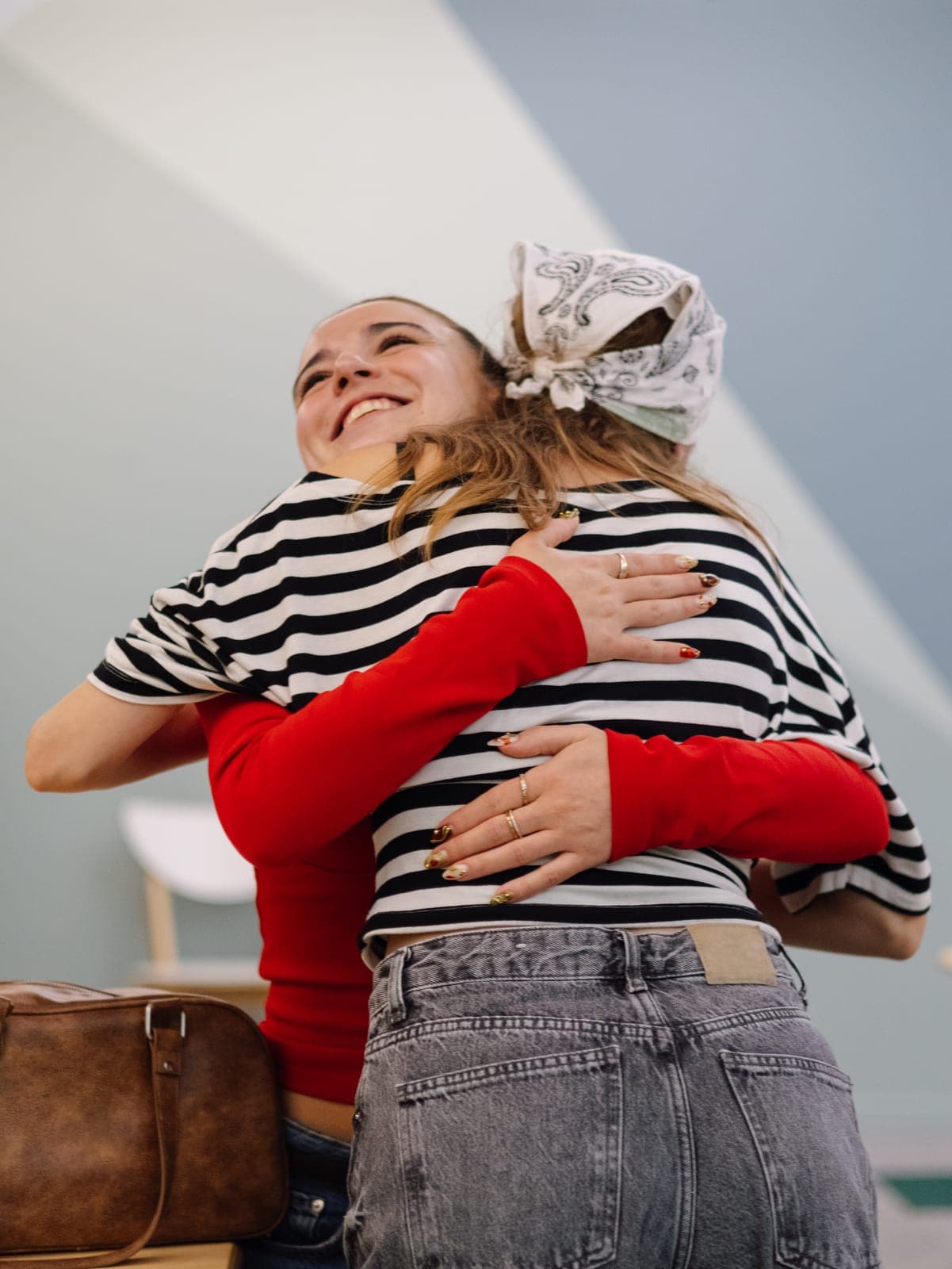 Two team members celebrating with a hug during a session at the Portugal offsite