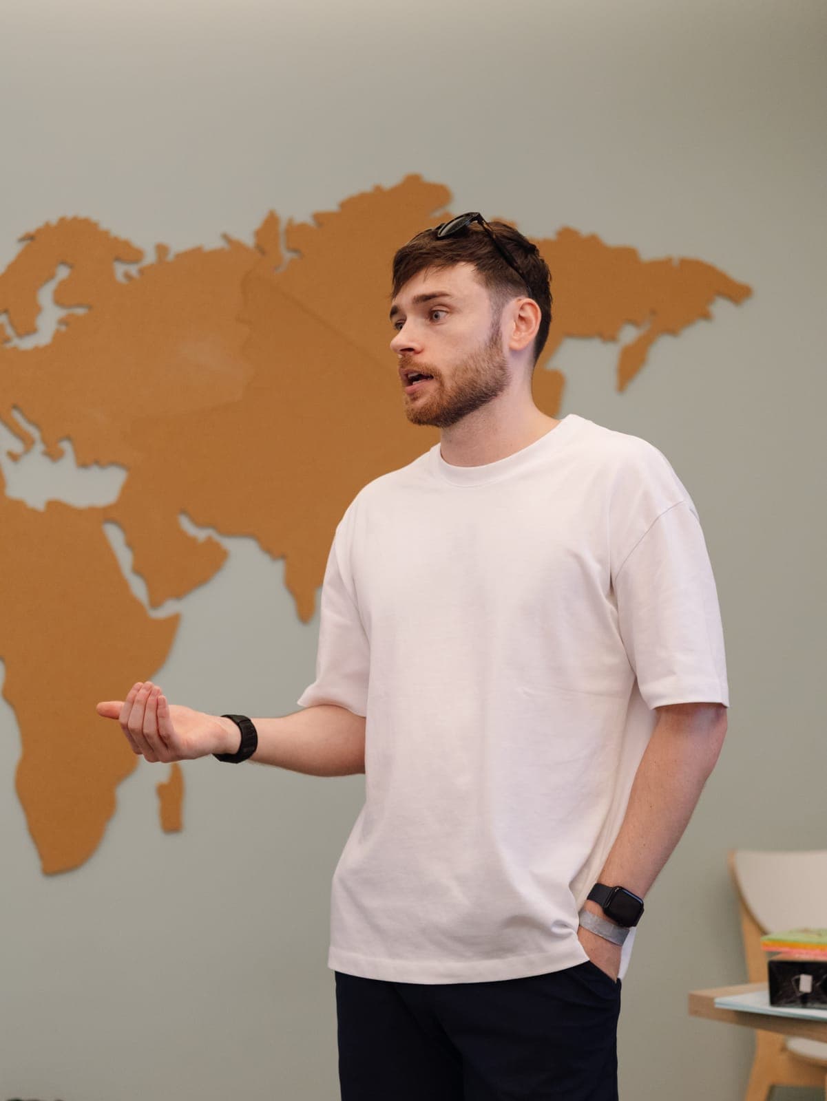 A team member presenting in front of a world map at the Portugal offsite