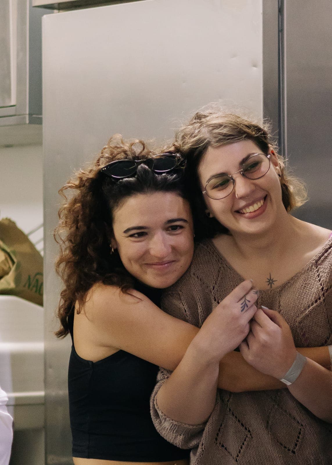 Two team members hugging during a pastel de nata baking class at the Portugal offsite